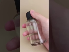 চিকিৎসার জন্য বিশেষ ঢাকনা সহ সূক্ষ্ম নকশার স্বচ্ছ মসৃণ গোলাকার কাঁচের বোতল